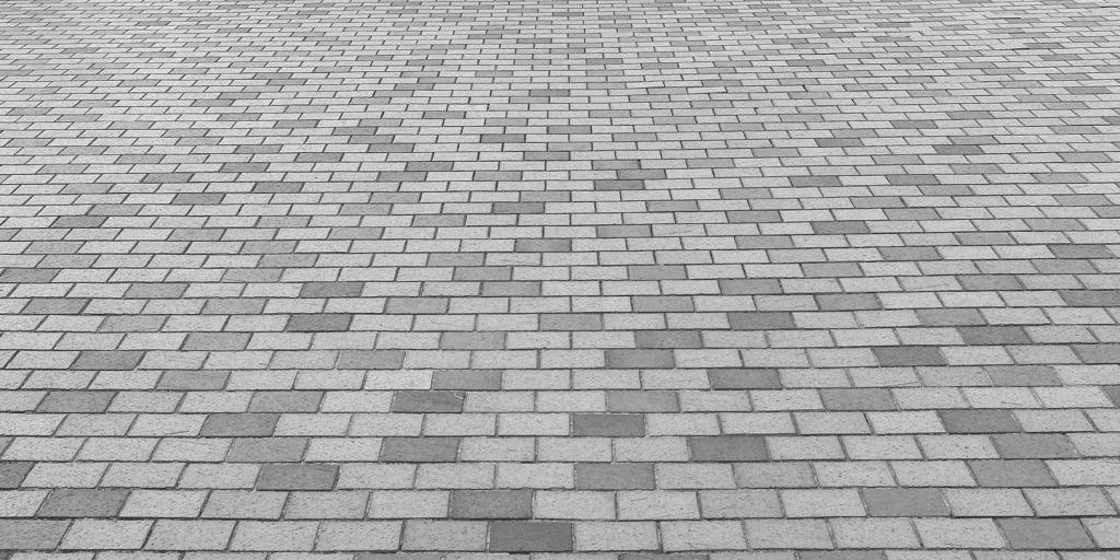 Perspective View of Monotone Gray Brick Stone Street Road. Sidew